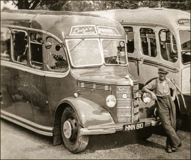 J. Lewis himself with two of his buses