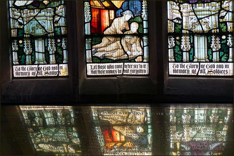 The panels of stained glass windows that commemorates those from the parish who died in the World Wars.